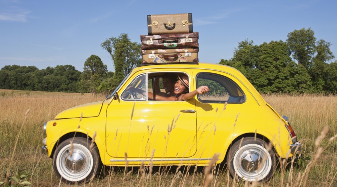 Couple in old-fashioned car on road trip